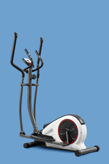 Modern exercise bike on blue background