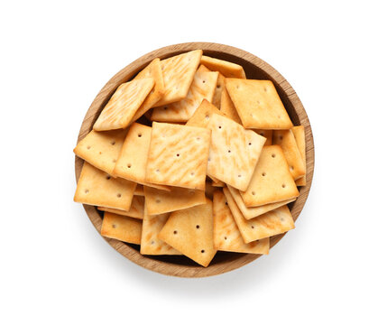 Wooden bowl with tasty crackers on white background
