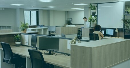 Working colleagues wearing smart clothes at monitors in open-plan office, copy space
