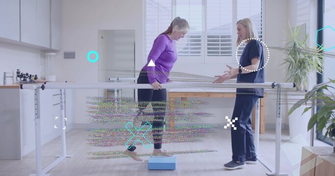 Woman in purple top balancing on foam block under parallel bars in kitchen, with therapist guidance