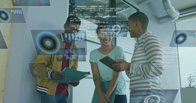 Reviewing holographic graphs three colleagues in modern office, holding folders and tablet - Powered by Adobe