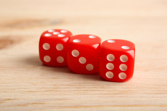 Red game dices on wooden background