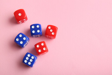 Different game dices on pink background