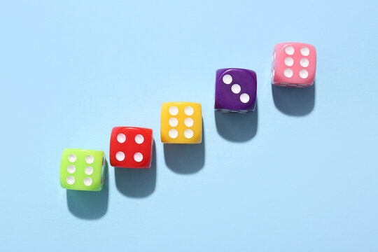 Colorful game dices on blue background
