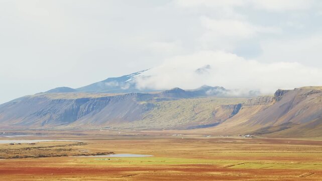 A scenic view of the Sn&aelig;fellsj&ouml;kull volcano and its glacier capped peak on the Sn&aelig;fellsnes Peninsula in Western Iceland.