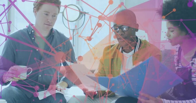 Three colleagues holding mugs unfolding blue folder and examining charts for business consensus