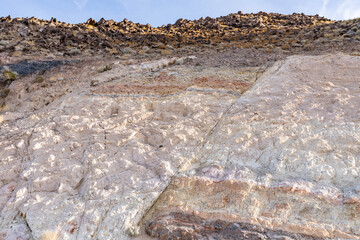Charlie Brown Outcrop. Cutting or Cut (earthworks). Shoshone in Inyo County, California geology.  devitrified pumice tuff, welded tuff and vesicular vitrophyre. The volcanic rocks are cut by faults. 