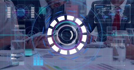 Grid appearing over table initiating rotating rings while team noting charts for business insight - Powered by Adobe