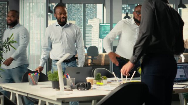 Multinational company staff engaged in a corporate event for business partnership, coworkers analyze targets and proposals, planning forecasts with stakeholders for investment. Camera B.