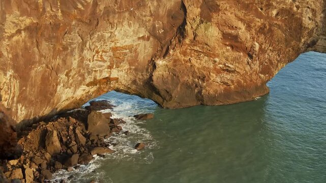 A video of the iconic Gatklettur Rock Arch a natural stone formation carved by the powerful Atlantic Ocean waves on the rugged coastline of the Sn&aelig;fellsnes Peninsula in West Iceland.