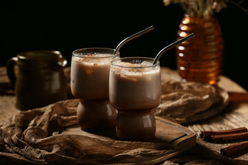 Glasses of cold cocoa drink on wooden table