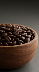 Roasted coffee beans in a rustic wooden bowl against a muted background
