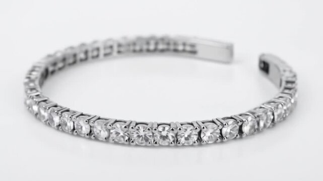Elegant Silver Tennis Bracelet with Clear Sparkling Gemstones on a Clean White Background