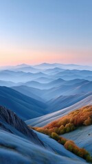 Majestic layered mountain ranges bathed in the soft glow of a pastel sunrise with golden autumn foliage on foreground slopes