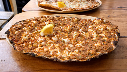 A Lahmacun with a slice of lemon on top