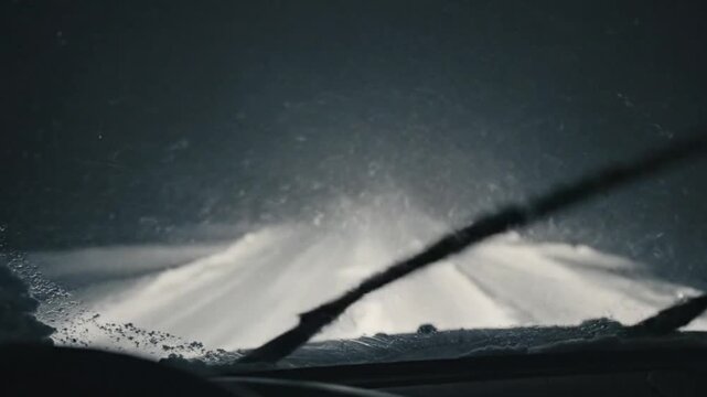 Driving in heavy snowstorm remote highway winter scene nighttime front view safety precautions