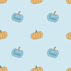 Seamless pattern with blue and yellow pumpkins
