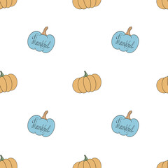 Seamless pattern with blue and yellow pumpkins