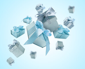 Gift boxes flying in air on light blue gradient background