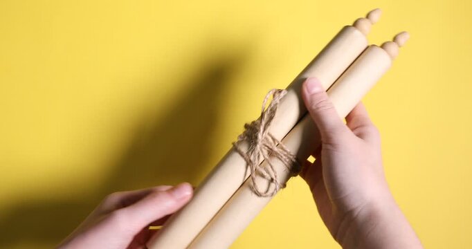 Woman with scroll of old parchment paper on yellow background, closeup