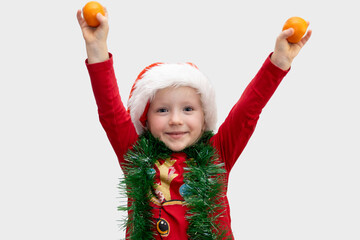 Joyful child celebrating with oranges and festive decorations during the holiday season