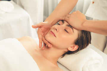 Caucasian woman enjoying relaxing anti-stress head massage and pampering facial beauty skin...