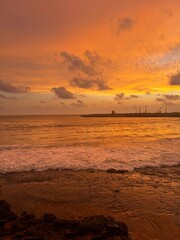 A stunning sunset over the Galle Face sea, painting the waves and sky in golden hues&mdash;a peaceful moment by the ocean.