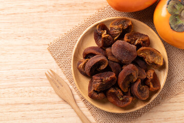 Dried persimmon on wooden plate ready to eating, Sweet and chewy, Table top view