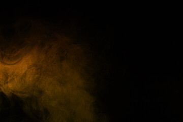 Dark background with golden orange smoke or fog effect perfect for cinematic scenes fire or light overlays and dramatic graphic design projects. Ideal for creating warm, mysterious atmosphere visuals.