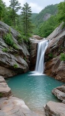 Fototapeta premium Serene Waterfall Cascading into Turquoise Pool Surrounded by Rocky Cliffs and Lush Green Forest Under a Cloudy Sky
