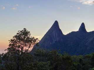 Dramatic Mountain Peaks at Sunset with Tree Silhouette