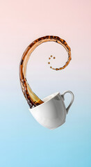 A cup of coffee floating in the air with a frozen motion effect.