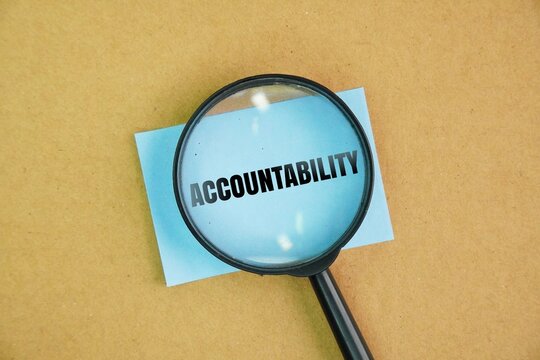 A magnifying glass and paper with the word ACCOUNTABILITY. concept of responsibility. responsibility for one's actions and decisions and being accountable for their outcomes