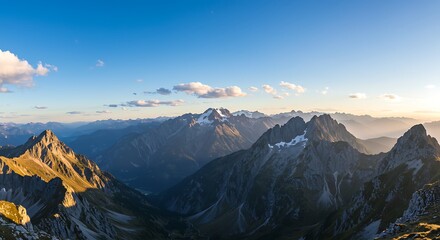 Majestic Mountain Range Under a Clear Blue Sky at Sunset.