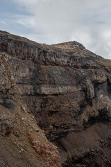 Majestic mountain landscape. The rim of a volcanic crater. View of the rock layers on the inner...