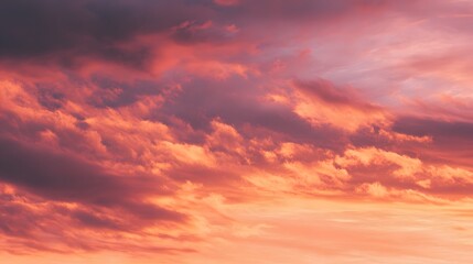 Obraz premium Dramatic cloudscape displays intense shades of pink, orange, and deep violet at twilight.