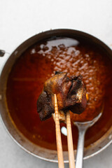 overhead view of fried goat meat in chopsticks, top view of fried mutton