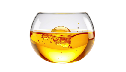 Round glass filled with amber liquid and bubbles, black backdrop
