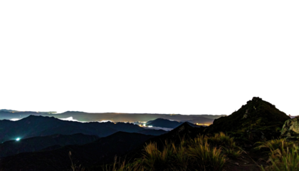 Night panorama of mountain range lit by distant cityscape lights