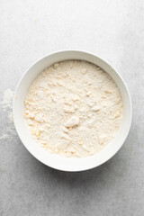 butter and flour being mixed together, butter and flour mixed into rough pastry, butter and flour being used to make cookie dough or pie dough
