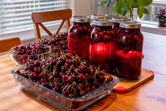 View at large of jars with homemade cherry compot inside