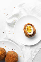 Overhead view of fried scotch egg, top view of cross-section of scotch eggs