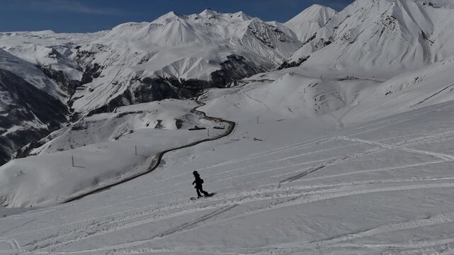 Aerial view of man is freeriding in Caucasus mountains, Gudauri, Georgia.