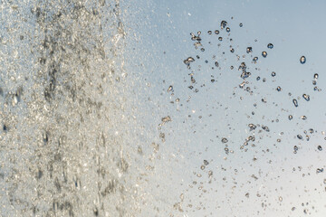 Splashes and jets of water against light background.