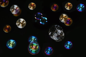 Beautiful Colorful Soap Bubbles Floating on Black Background.