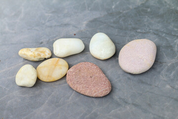 Various stones are placed on the marble floor.