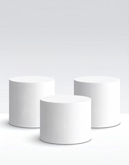 Three white cylindrical stands in a clean, bright space