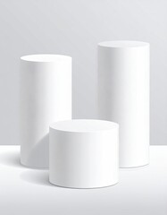 Cylindrical, white product podiums against a soft grey backdrop