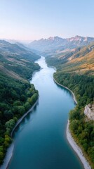 Wide Angle Aerial View of a Majestic River Flowing Through Verdant Green Mountain Valleys Under a Clear Blue Sky