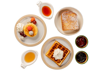 A delightful breakfast arrangement of waffles, pancakes, and toast with various toppings